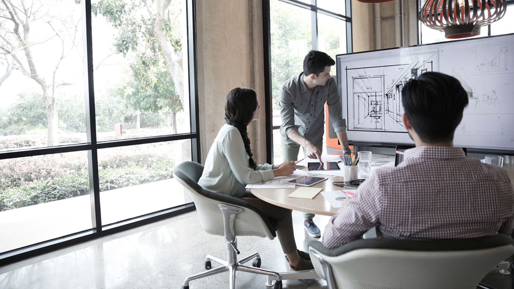 Colleagues reviewing plans on a white board
