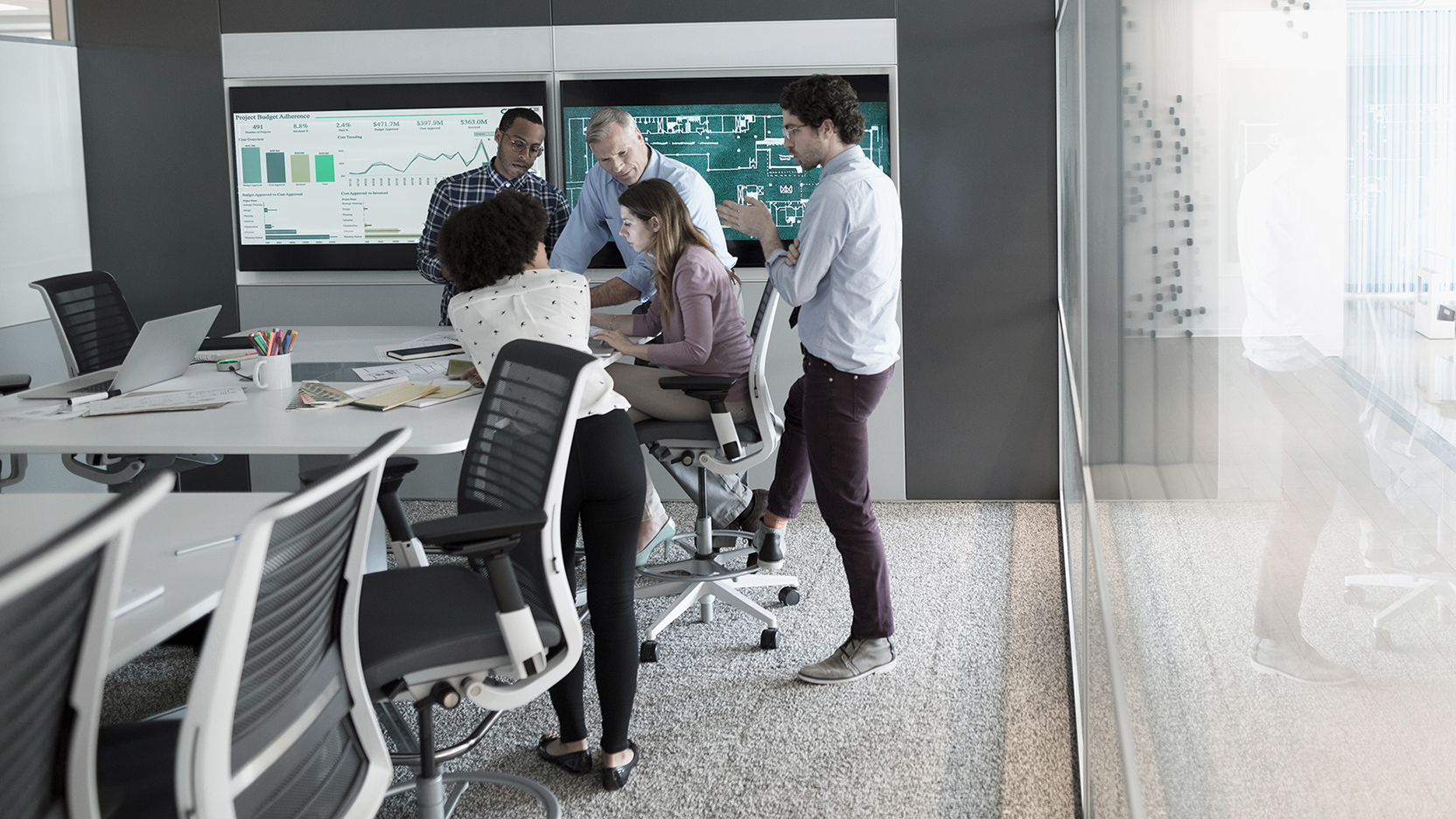 Colleagues gathered around an office table