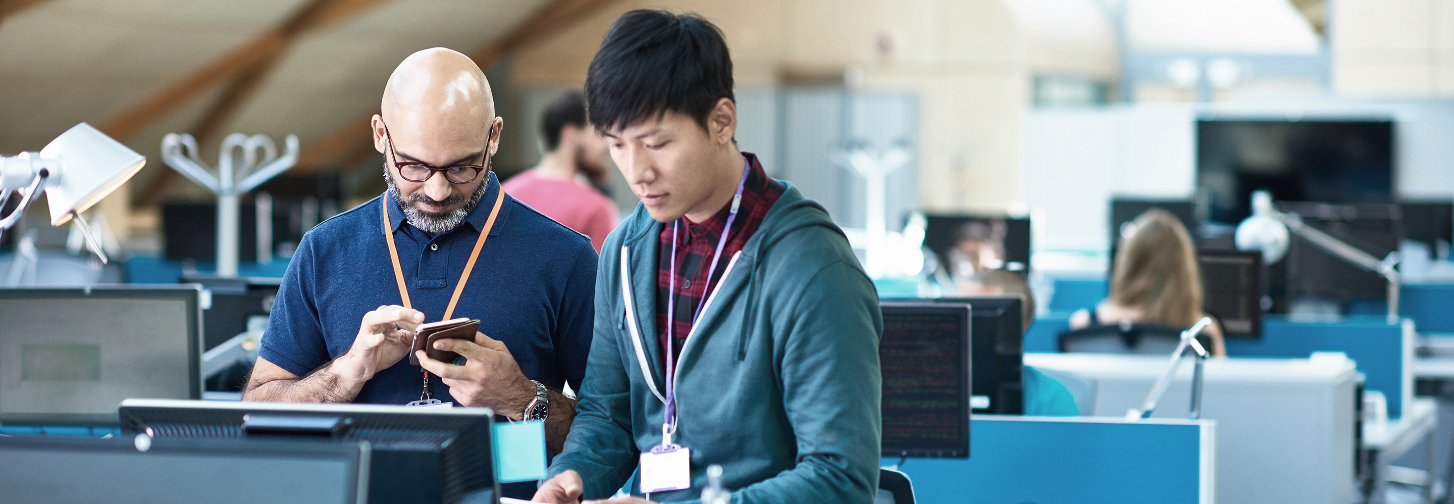 Tech professionals working on a computer workstation