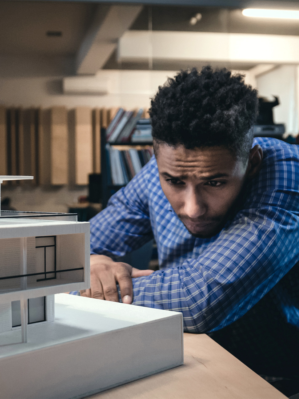 Image of a professional examining a model building