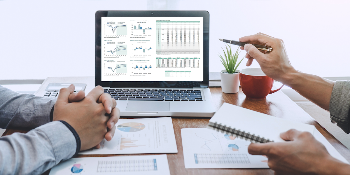 employees reviewing hotel market data